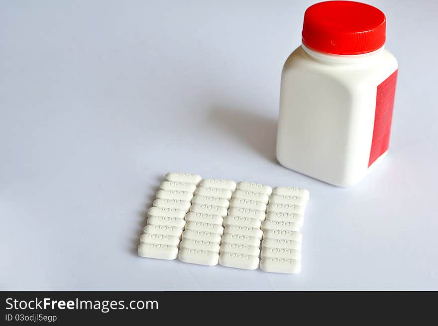 A row of pills with bottle