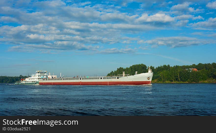 Barge going down the river on a summer day. Barge going down the river on a summer day