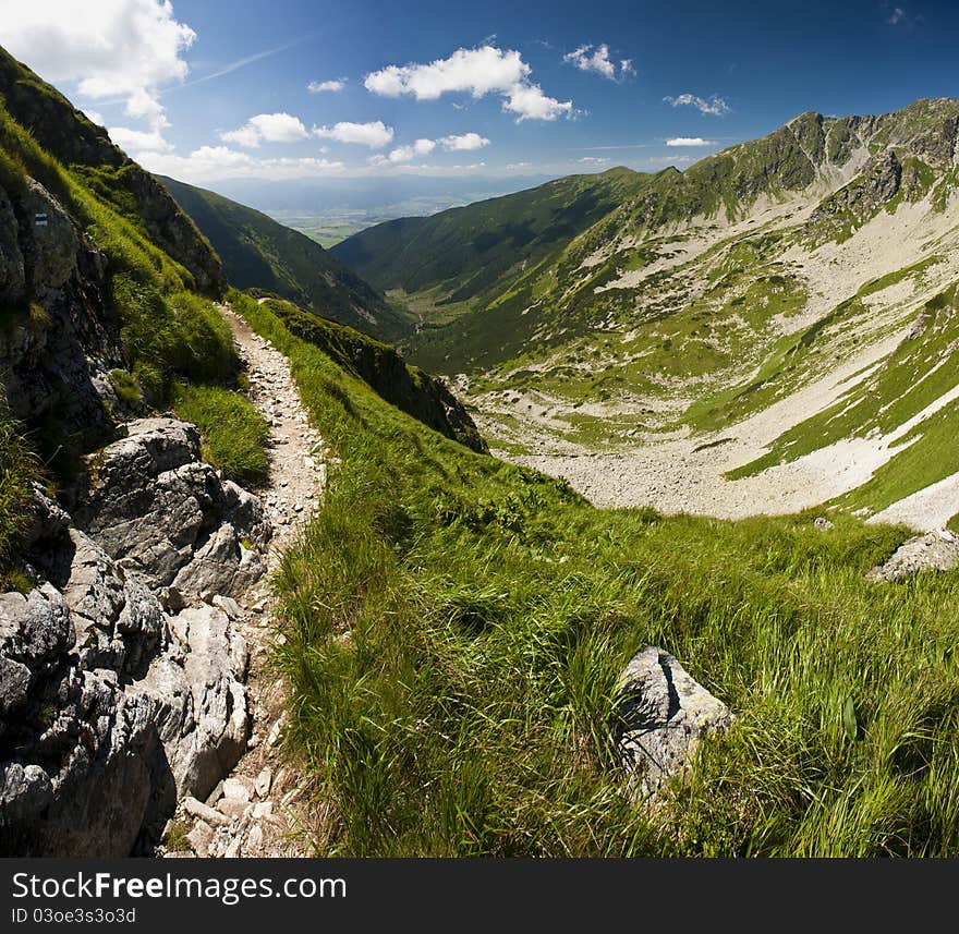 Panorama from mountains in summer day with a path. Panorama from mountains in summer day with a path