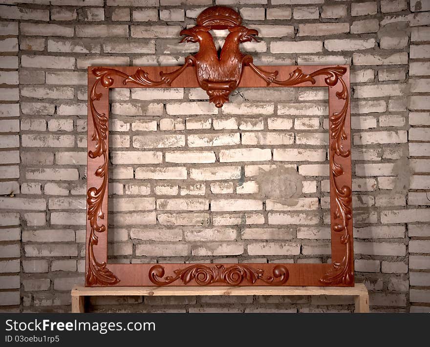 Old grunge wall and antique frame against it