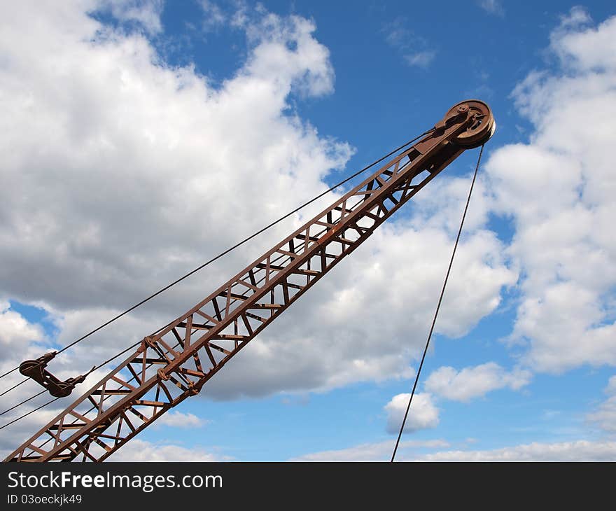 Silhouette of a crane boom against a cloudy sky. Silhouette of a crane boom against a cloudy sky.