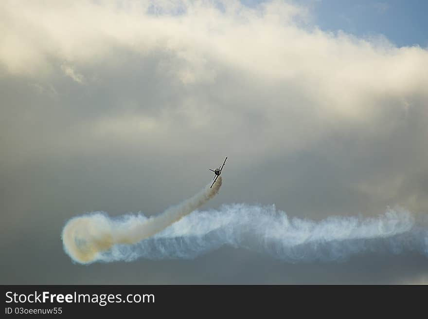 Airplane performing difficult maneuver in the sky. Airplane performing difficult maneuver in the sky.