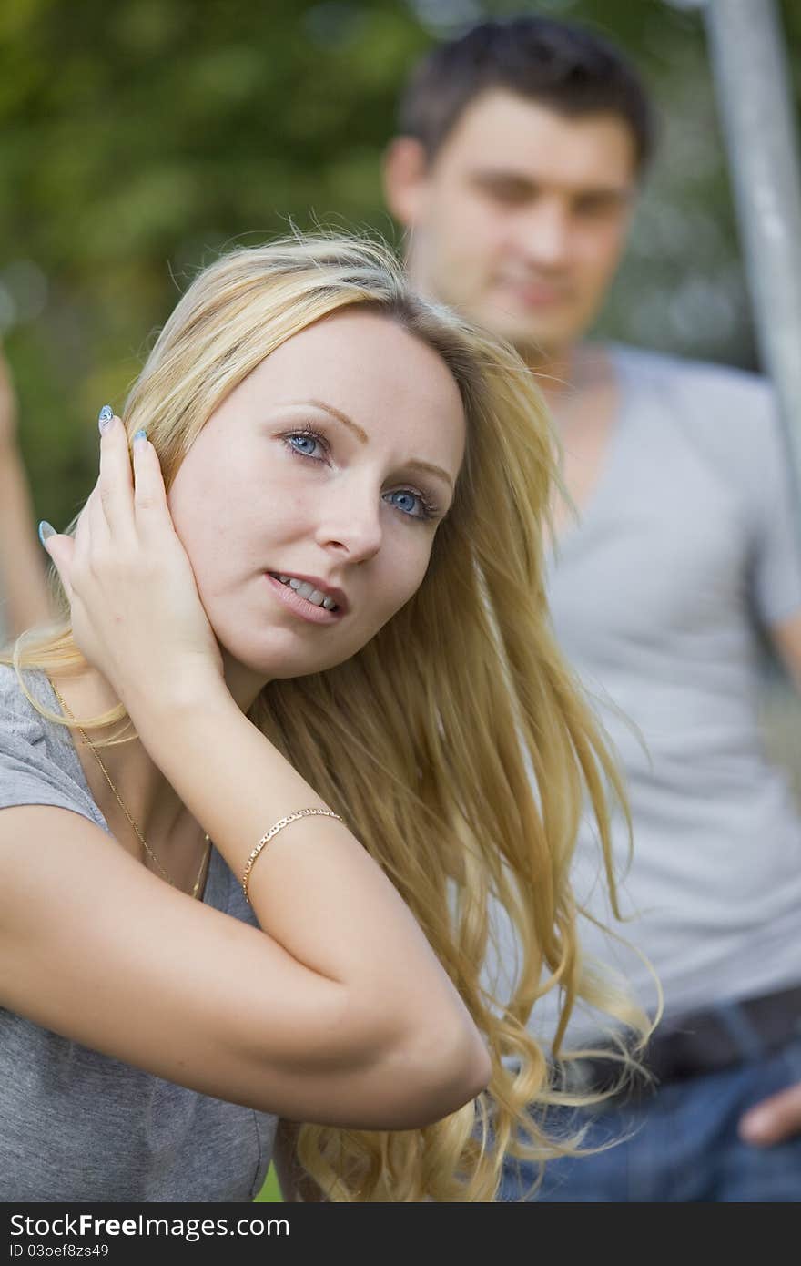 Young couple outdoor - focus on female in foreground