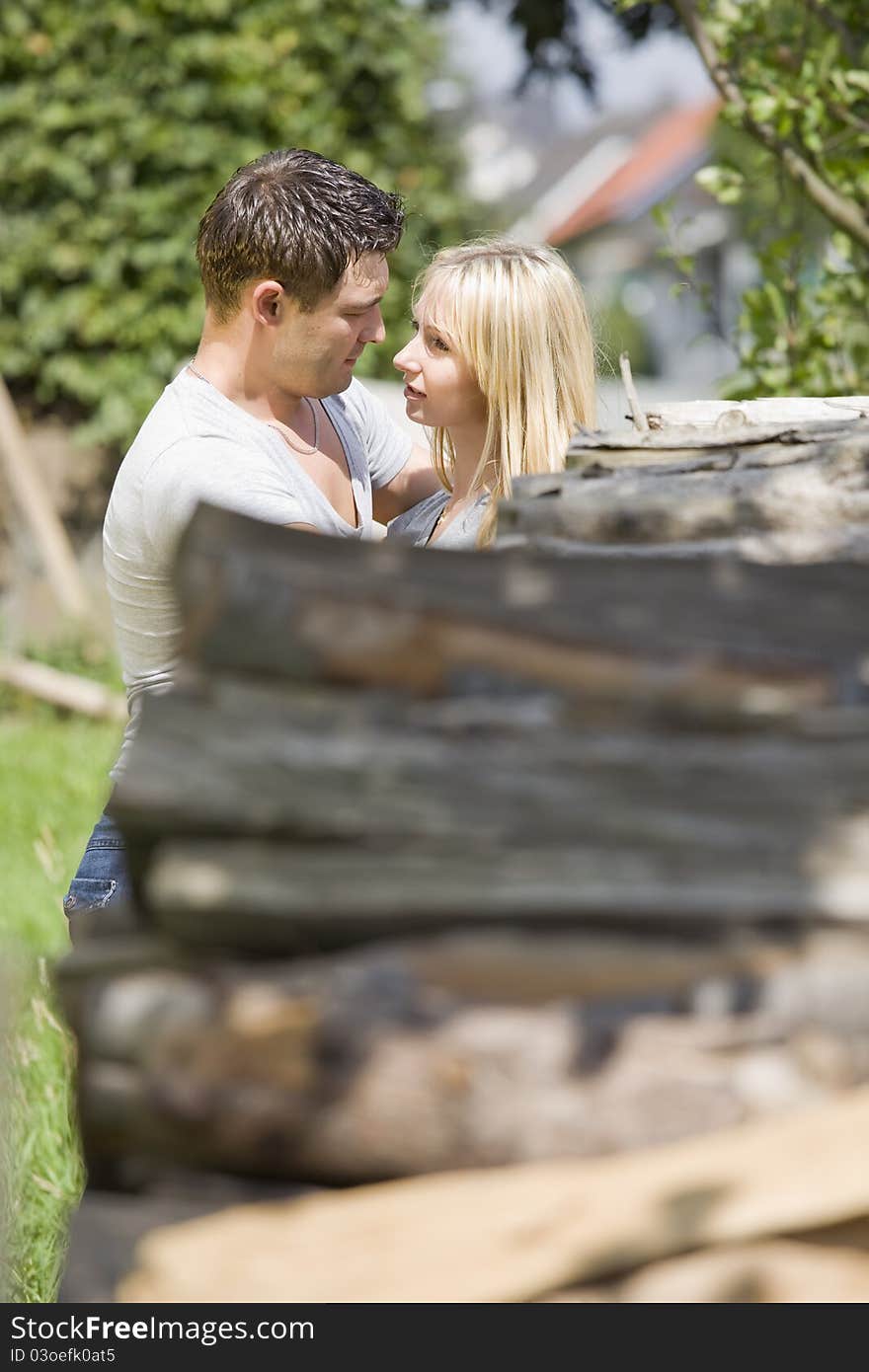 Young romantic couple embracing in countryside