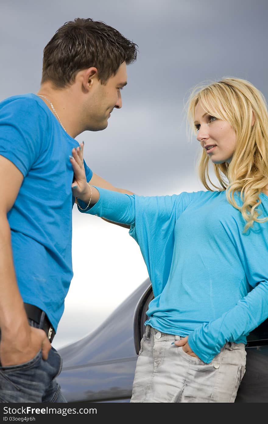 Young love couple outdoor by the car