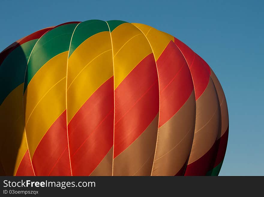 Image of a hot air balloon against blue sky. Image of a hot air balloon against blue sky