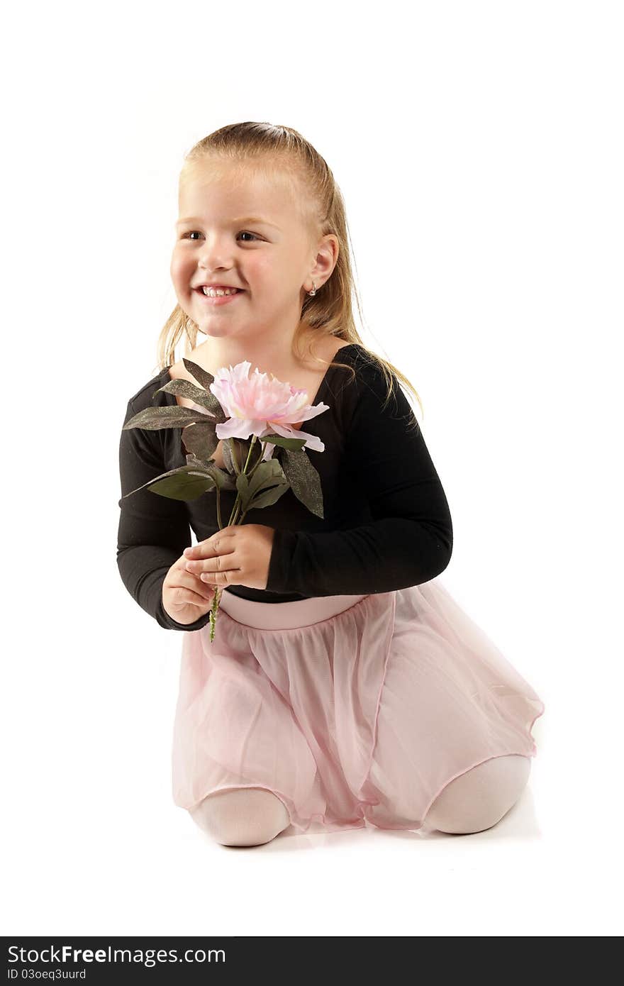 A pretty preschool ballerina holding a large, pink flower. on white.