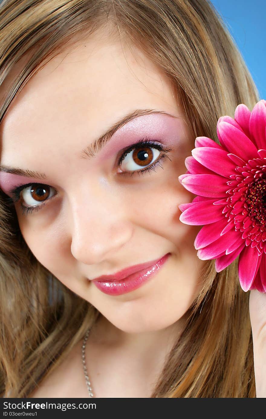 Attractive smiling woman portrait on blue background