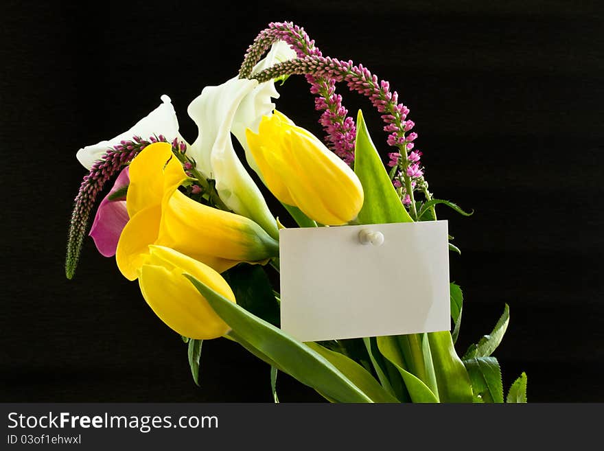 Beautiful bouquet of tulips and calla lilies on a black background