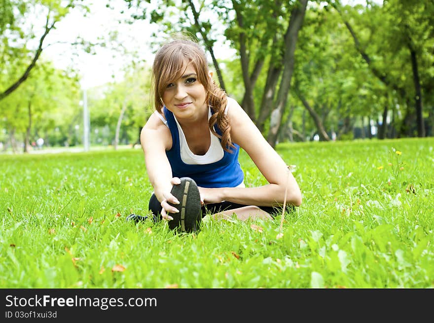 Young woman is engaged in yoga, in summer forest on a green grass. Young woman is engaged in yoga, in summer forest on a green grass