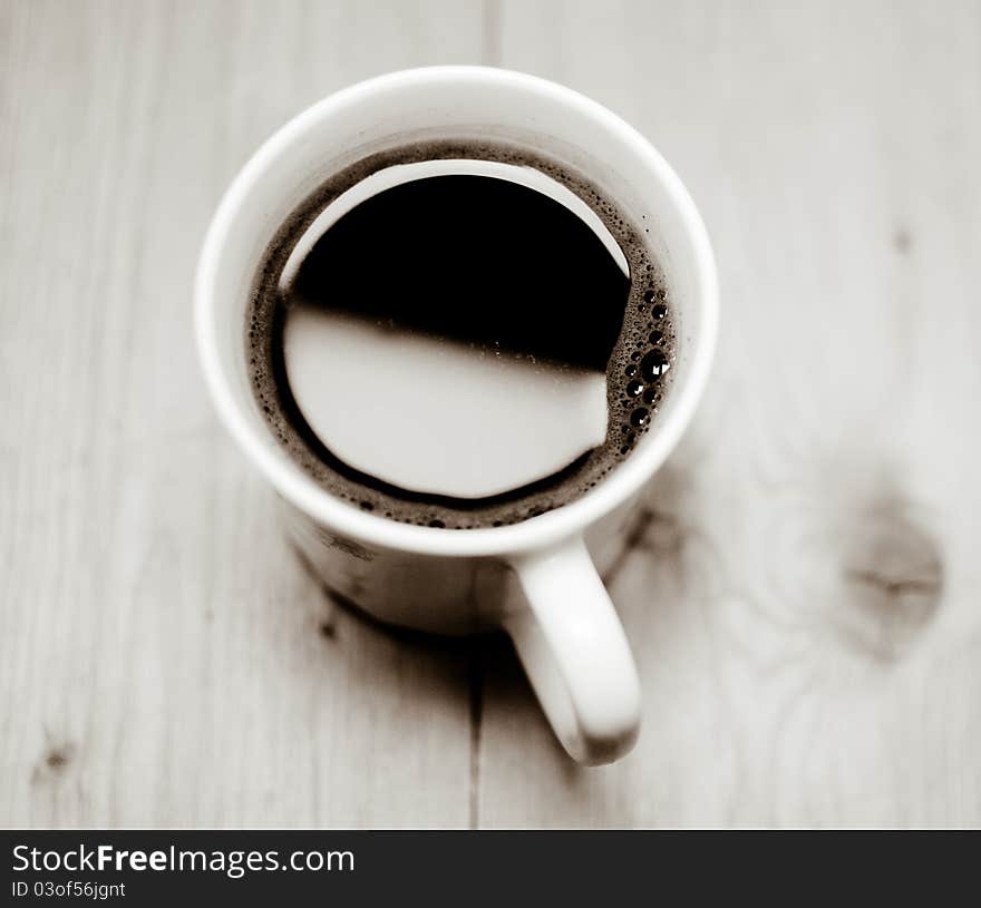 A cup of coffee is on the table. Good morning!. A cup of coffee is on the table. Good morning!