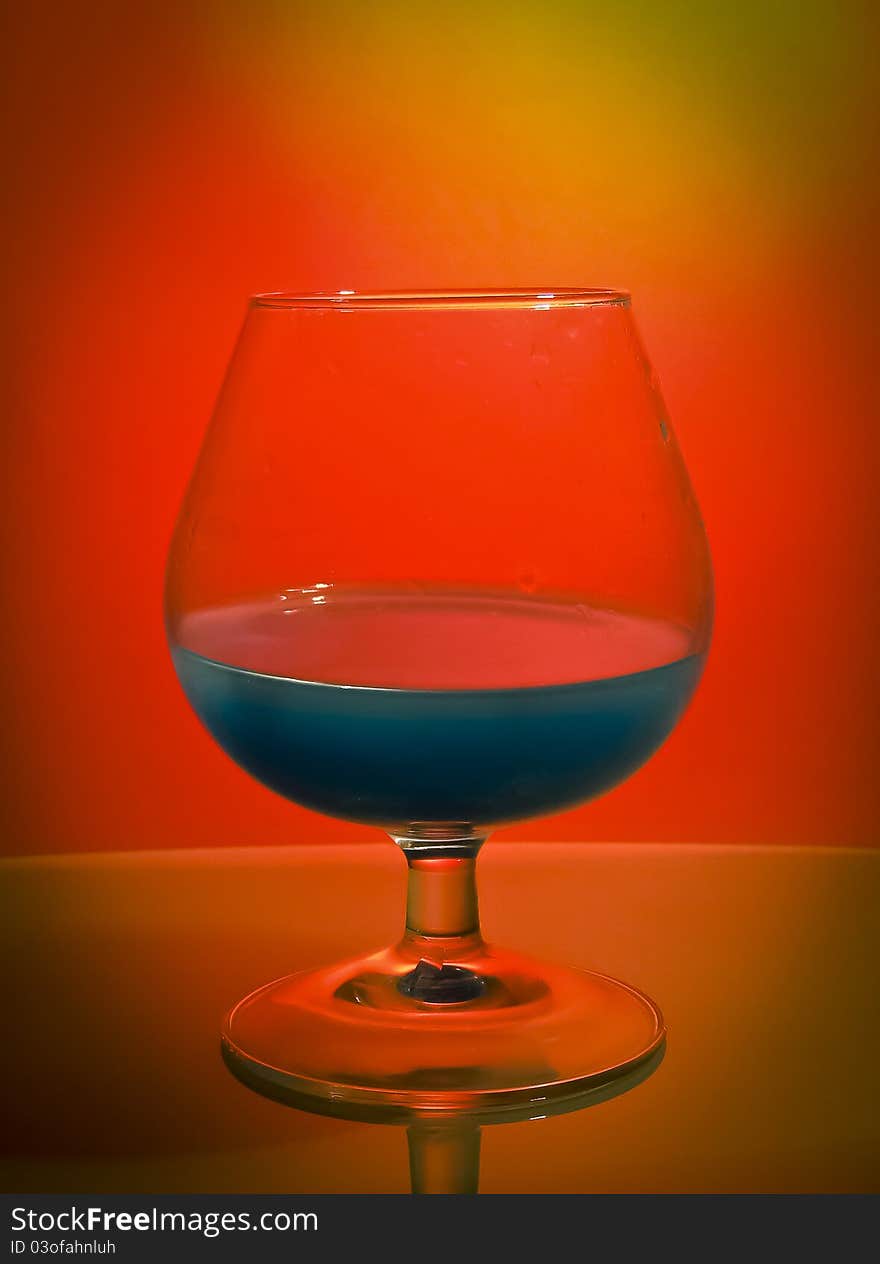 A glass with blue liquid. A glass with blue liquid.