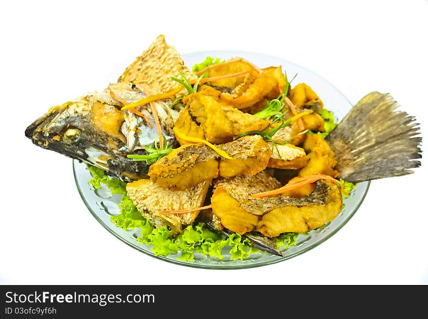 Fried fish on dish with white background