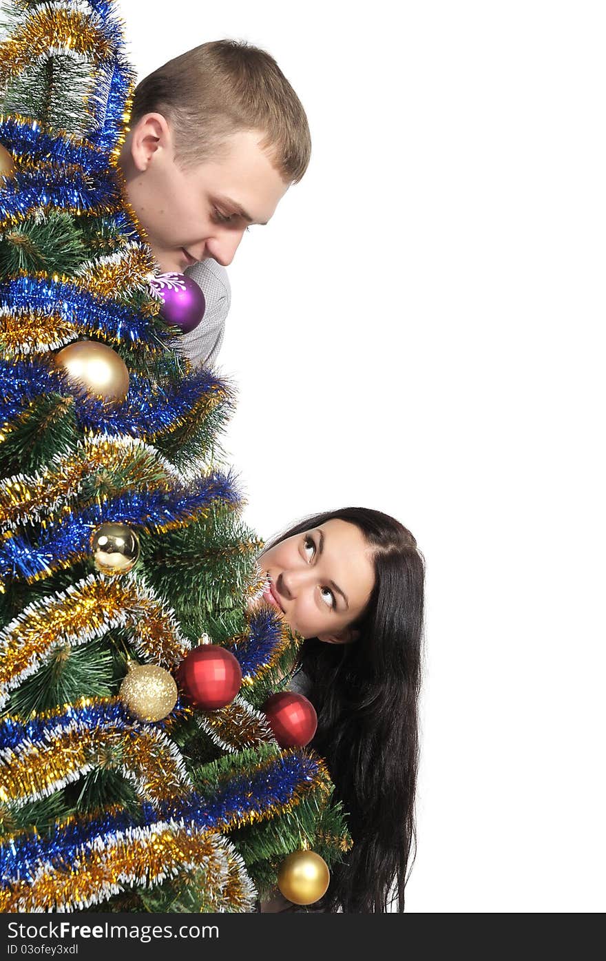 Man and woman staring at each nodule because of the Christmas Tree. Man and woman staring at each nodule because of the Christmas Tree