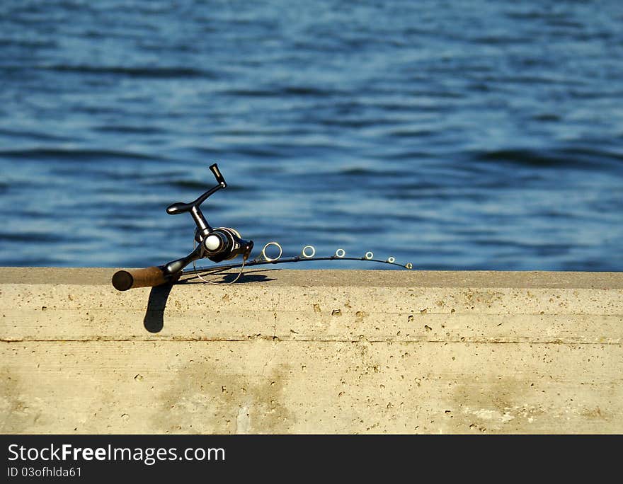 A fishing rod on a concrete