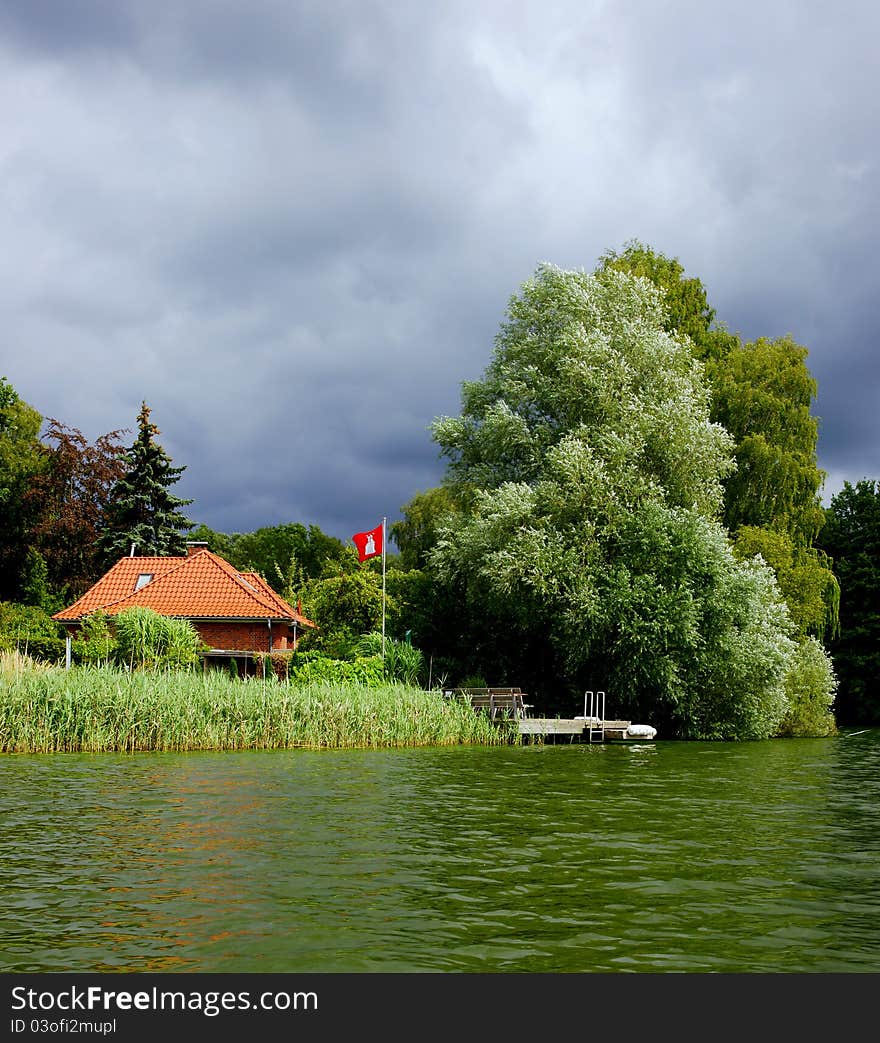 A storm is moving in on a house on Lake Ziegelsee near Moelln, Schleswig-Holstein (Germany). A storm is moving in on a house on Lake Ziegelsee near Moelln, Schleswig-Holstein (Germany).