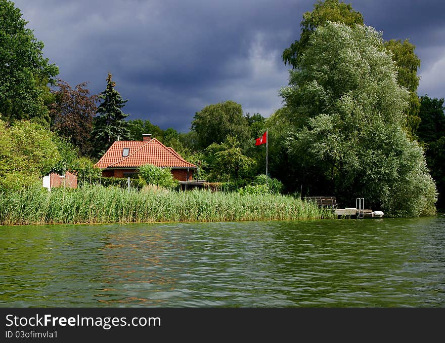 A storm is moving in on a house on the shore of Lake Ziegelsee near Moelln in Northern Germany. A storm is moving in on a house on the shore of Lake Ziegelsee near Moelln in Northern Germany.