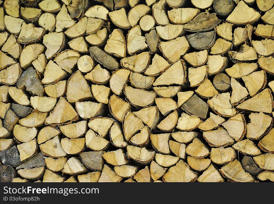 Chopped firewood arranged in a big stack. Chopped firewood arranged in a big stack