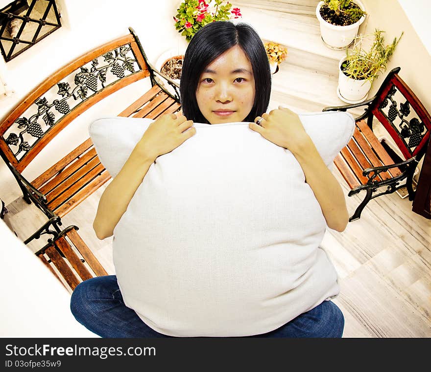 Young woman Dreaming of a new home. Holding a pillow in front of her