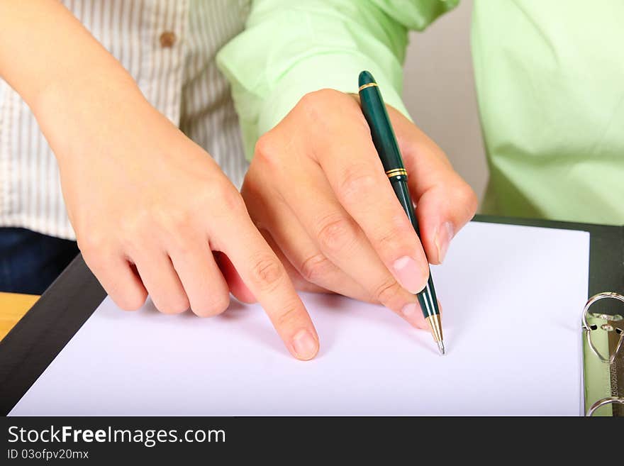 Two businesspeople signing a letter. Only hands in the picture