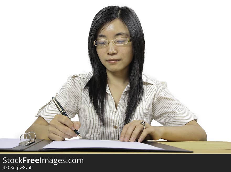 Chinese businesswoman, sitting at desk writing