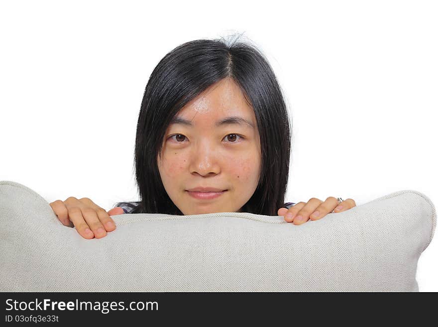 Young chinese woman hugging a pillow