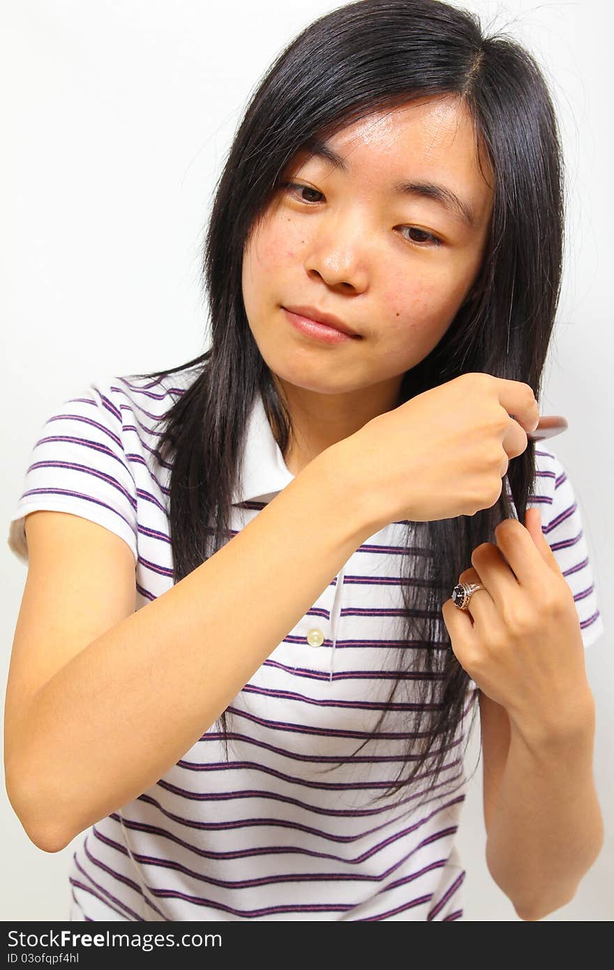 Young chinese woman brushing her hair