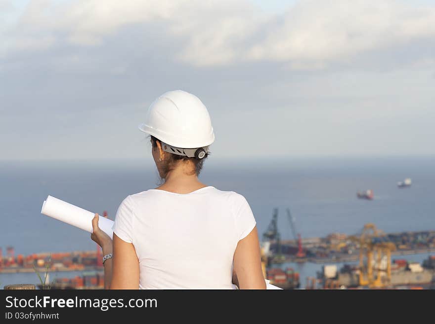 Female architect looking at port