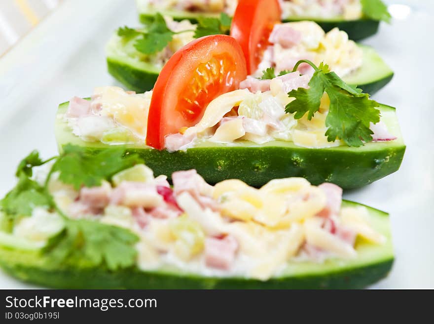 Cucumbers stuffed with ham, cheese and radish. Cucumbers stuffed with ham, cheese and radish