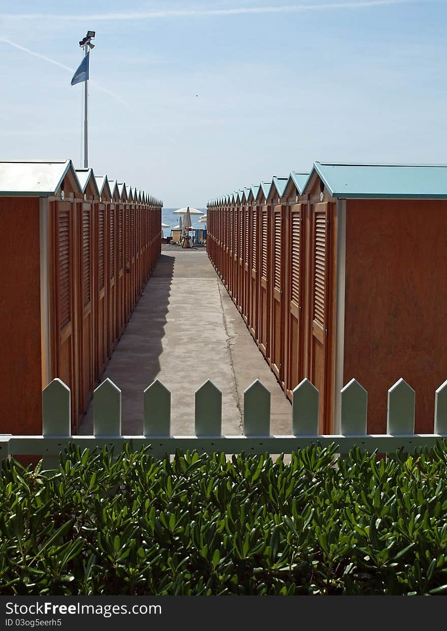 Rows of beachcabins forming a pathway to the beach