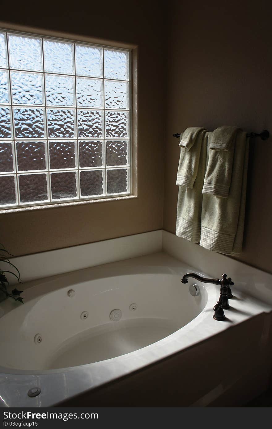 Private master bathtub with jacuzzi jets and glass block privacy window. Private master bathtub with jacuzzi jets and glass block privacy window.