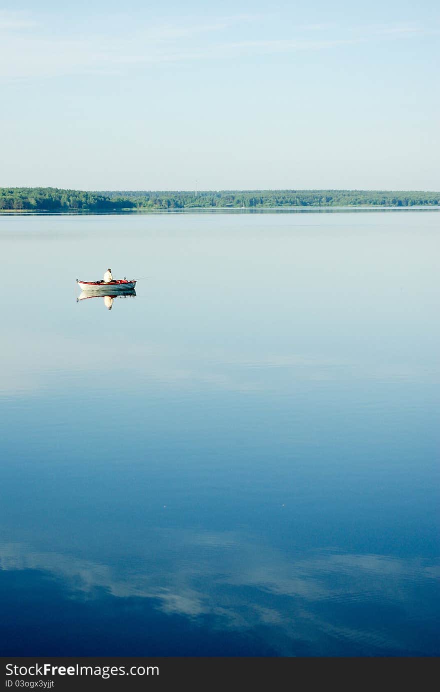 A rural blue lake and a green forest