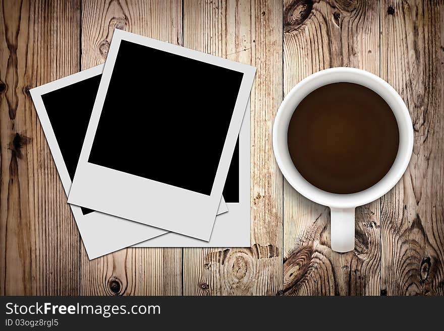 Blank photo and coffee on wooden background