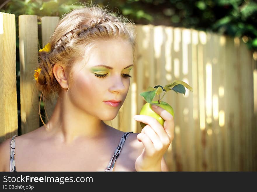 Young woman holding a green apple