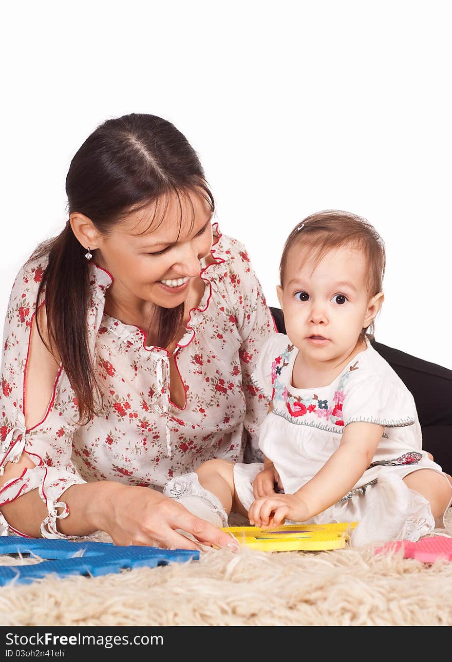 Mom with daughter on carpet on white