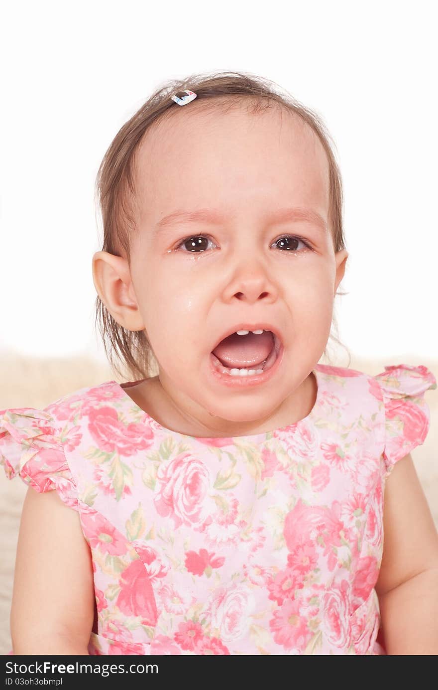 Cute little girl crying on a white