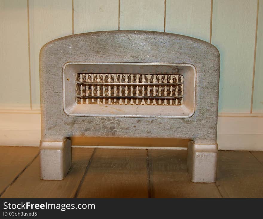 Old stone heater by a panel wall. Old stone heater by a panel wall