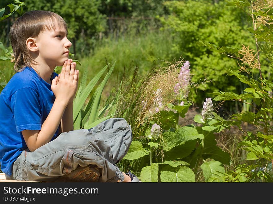 Cute young boy meditates at the nature. Cute young boy meditates at the nature