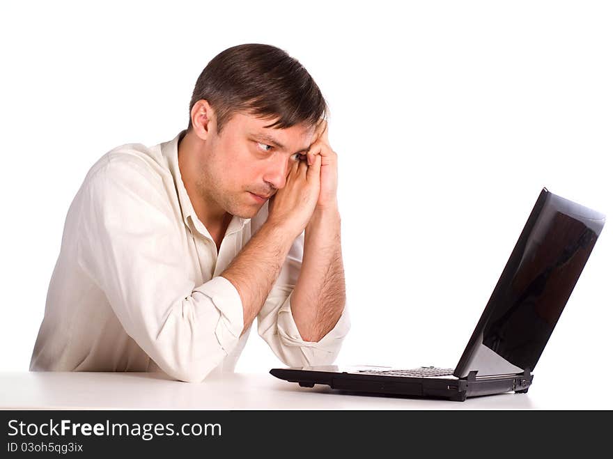 Cute young man with a computer on white. Cute young man with a computer on white