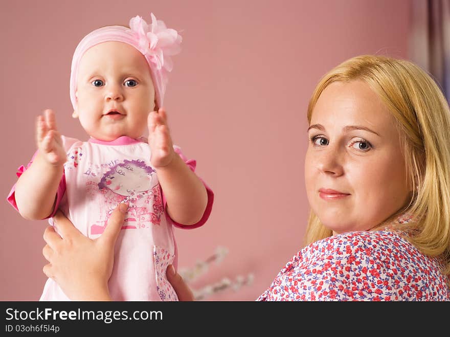 Cute mom with daughter on a pink. Cute mom with daughter on a pink