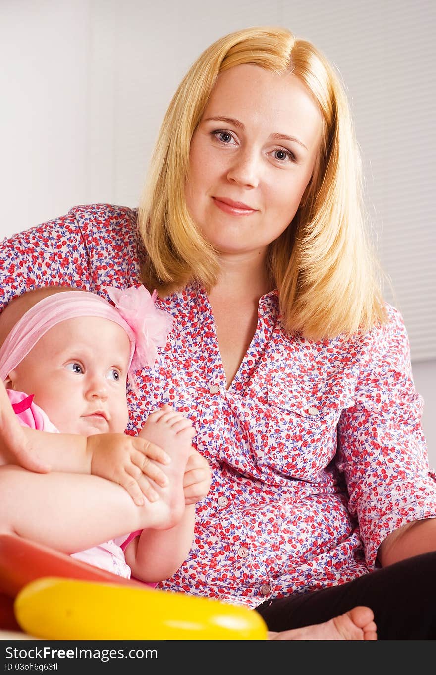 Cute mom with daughter on a white. Cute mom with daughter on a white