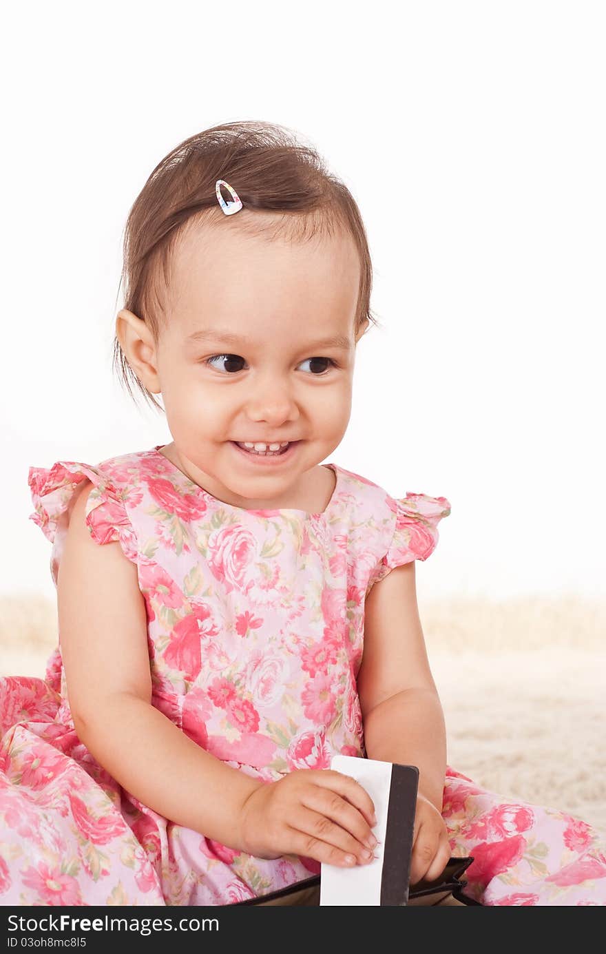 Little girl playing on a carpet on white. Little girl playing on a carpet on white