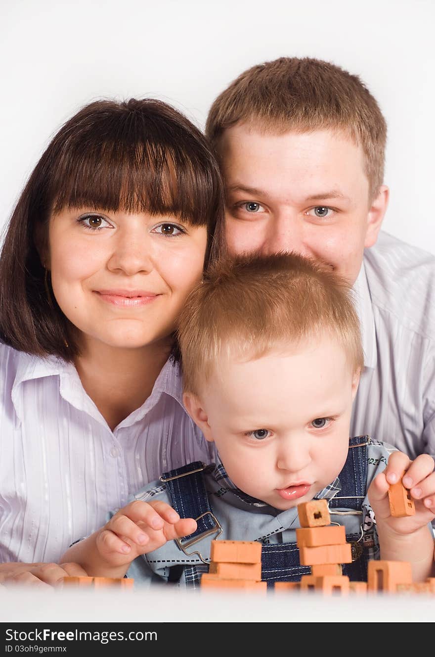 Nice family of a three playing at table. Nice family of a three playing at table