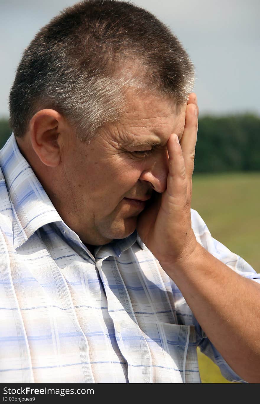 Sad man with his hand on his head