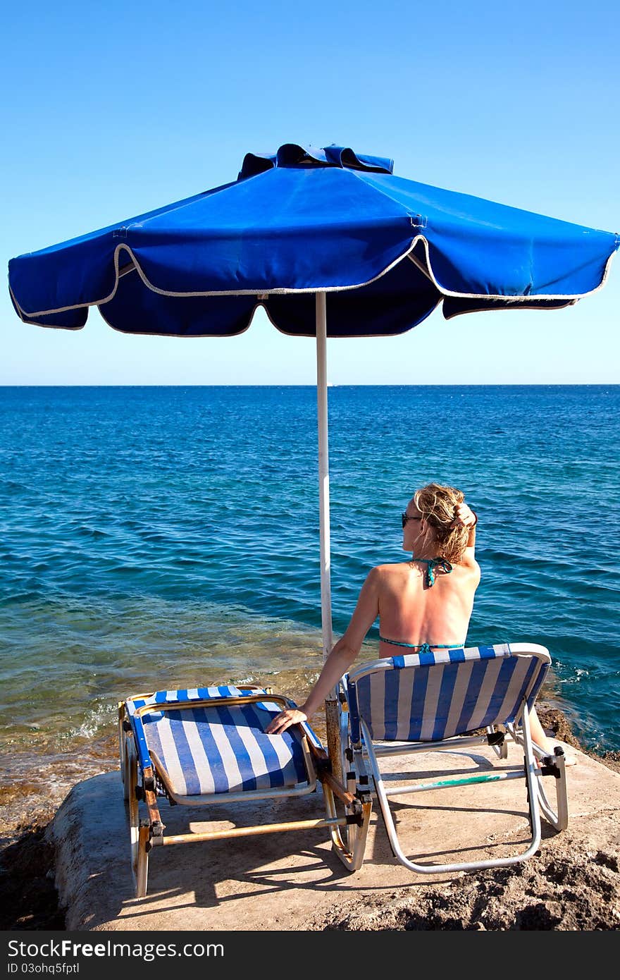 Young Woman Relaxing  On The Beach.