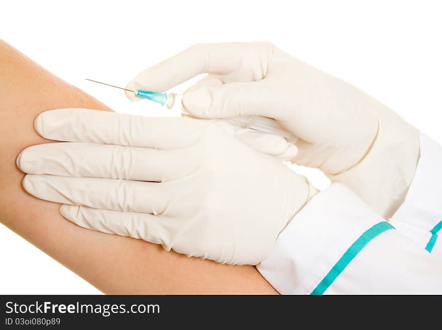 Syringe and a hand on a white background.