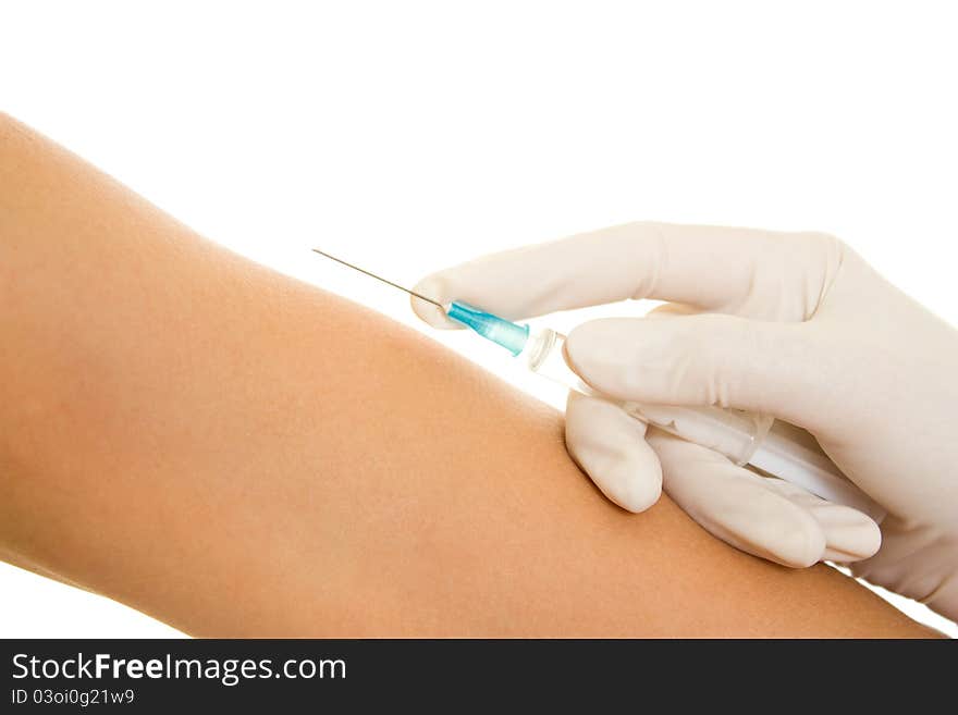 Syringe and a hand on a white background.