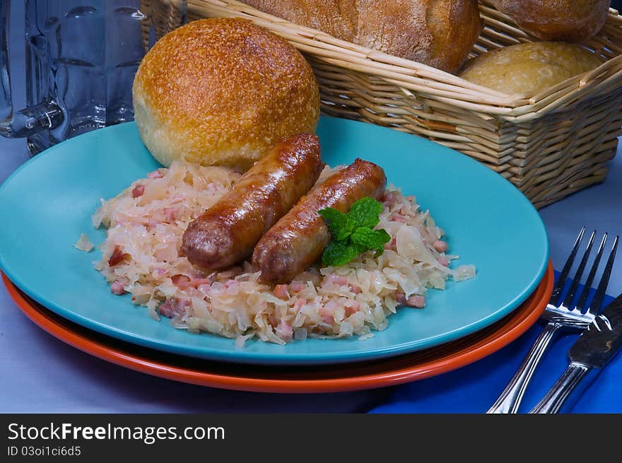 Sausages with sauerkraut and fresh rolls. Sausages with sauerkraut and fresh rolls