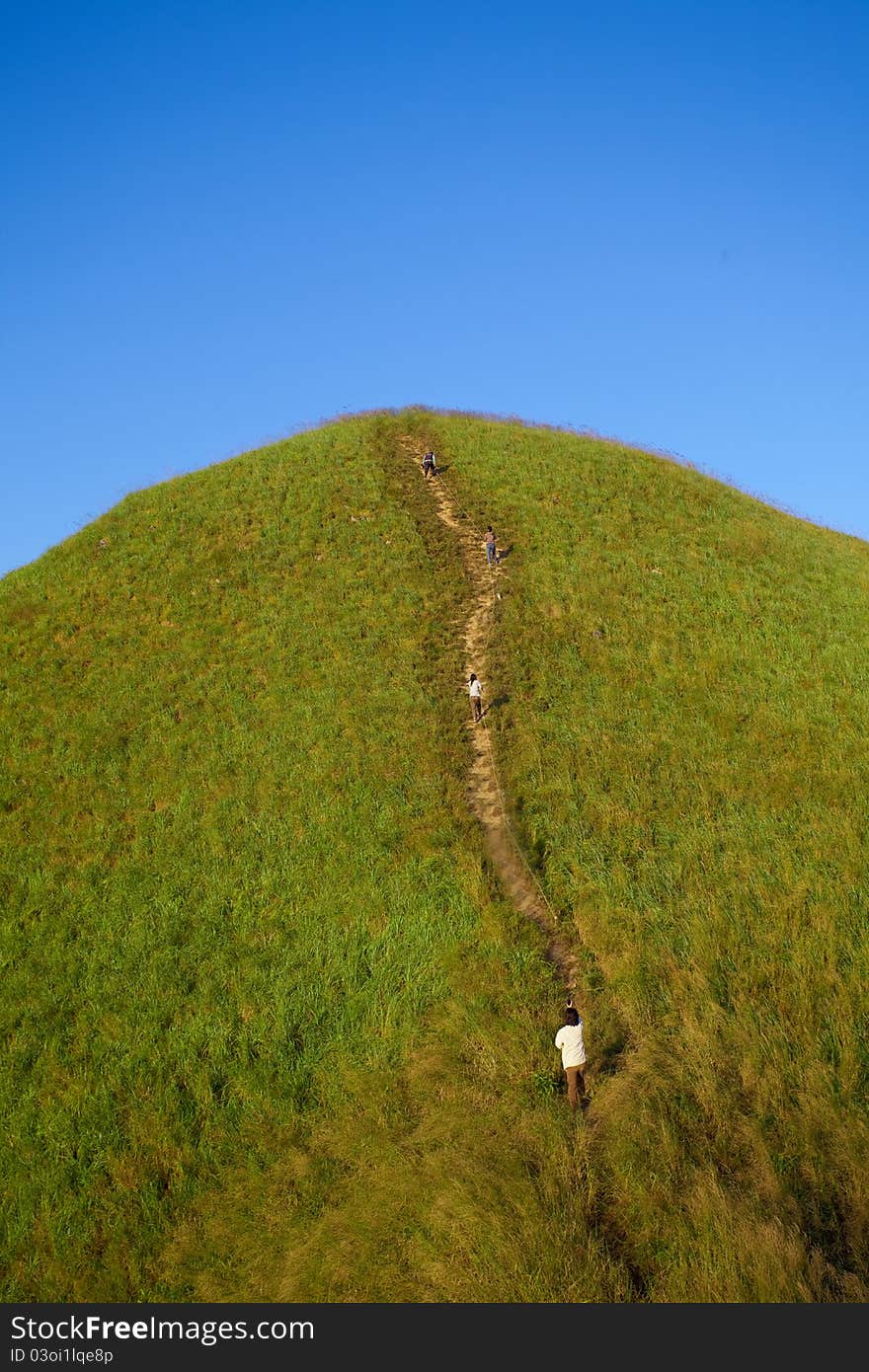 People in mountains with green grass