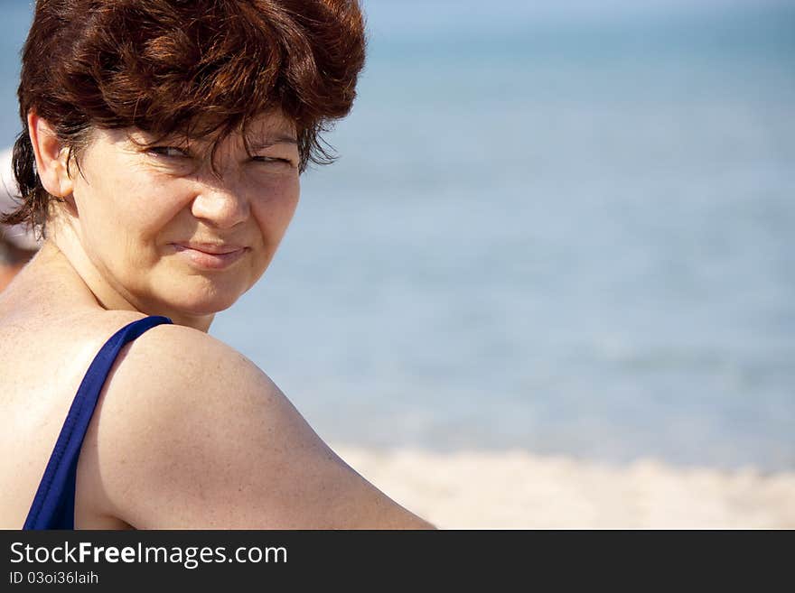 This photograph depicts a woman on the beach. This photograph depicts a woman on the beach.